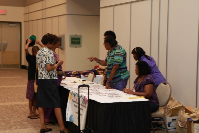 Attendees sign guestbook, pick up name tags, tee-shirts and goody bags