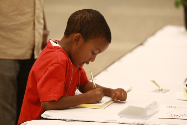 Dillan signing the guest book(From the pen of Bettie Griggs, Family Historian. This is my favorite picture. Dillan will be able to share his picture and the guest book with his name in his own penmanship, with his children and grandchildren, years and yea