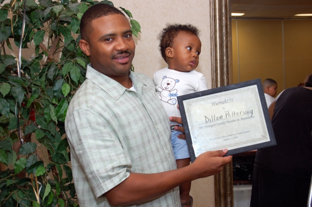 Dillan Petterway (with Dad, Dewayne) receives award for youngest attendee at reunion.