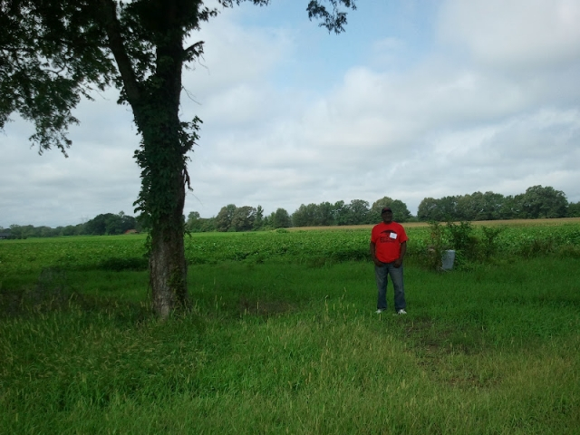 J.C. Beene stands where Obediah Beene's house once stood--the land that we tilled.
