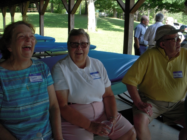 Smiling Sandy, not sure shes smiling Pam and Neelan ignoring the camera