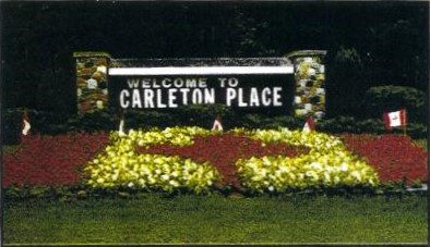 For four years, we planted  a 24-foot by 12-foot floral Canadian Flag, in front of the "Welcome to Carleton Place" sign