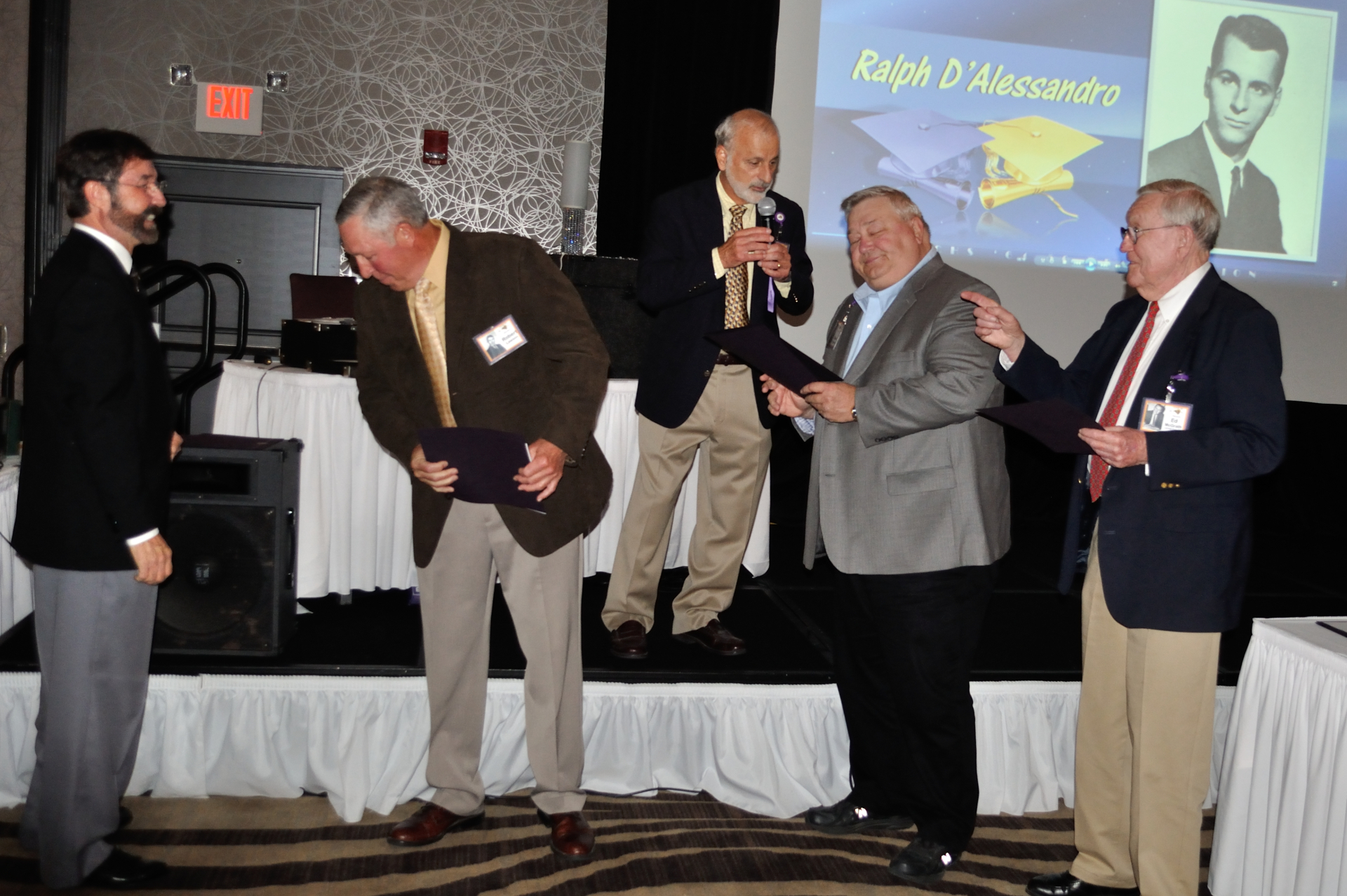 Don McNeil, Bob Lawson, Dave Forsberg, Coach McGrath, Ralph D'Alessandro on stage hosting sports awards